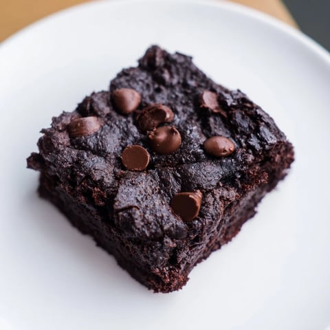 Warm, fudgy Black Bean Brownies with melted chocolate chips, a delicious gluten-free dessert option.