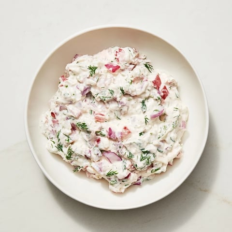 Creamy Sweet and Sour Pickle Relish Dip served in a bowl, perfect for dipping tortilla chips.