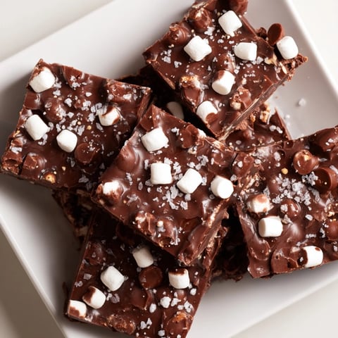 Golden squares of homemade Easy Marshmallow Fudge, featuring gooey marshmallows and a rich chocolate base.