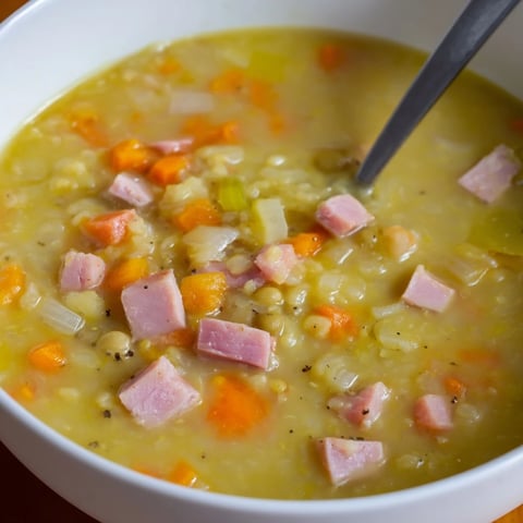Steaming bowl of hearty Split Pea and Ham Soup, showcasing a rich, thick texture, ready to serve.