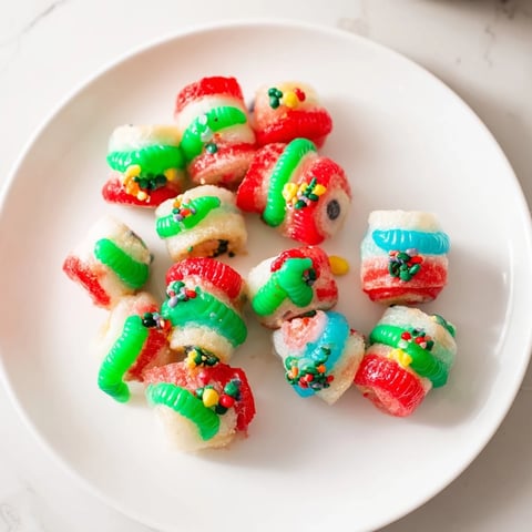Vibrant Easy Christmas Fruit Rollup Sushi with colorful candies and marshmallow filling, ready to eat!