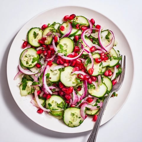 Healthy Cucumber Christmas Salad, a vibrant mix of cucumbers, pomegranate, and citrus dressing ready to serve.