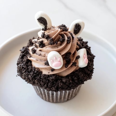 Bunny Burrow Cupcake Tray: A close-up of springtime cupcakes, chocolate buttercream "burrow" and fondant bunny feet.