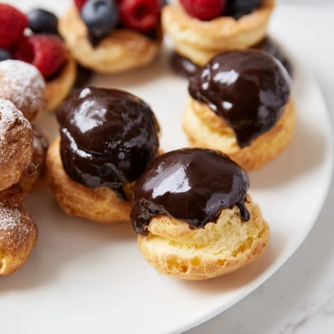 A close-up of beautifully arranged Piste de Train Mignardises, showcasing delicate French pastries.