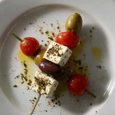 Holiday Cheers Olive and Feta Skewers: a beautiful appetizer with vibrant red tomatoes and salty olives.
