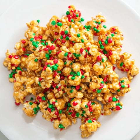 Sweet popcorn piles with vibrant red and green sprinkles, a holiday treat ready to enjoy.