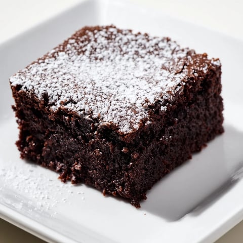 Fudgy brownie squares, dusted beautifully with powdered sugar, ready to indulge your sweet cravings.
