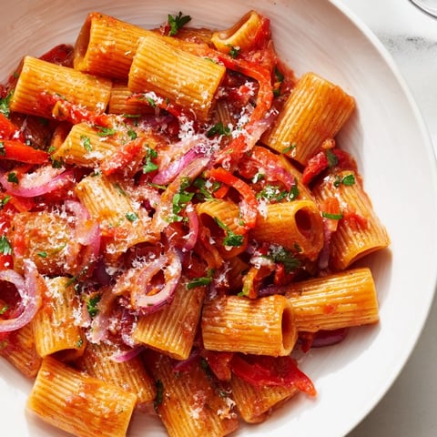 Steaming one-pot Diavola spicy pasta with vibrant bell peppers and a fiery red sauce, ready to serve.