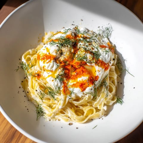 Golden Turkish pasta with paprika chili butter and creamy yogurt, ready to serve.