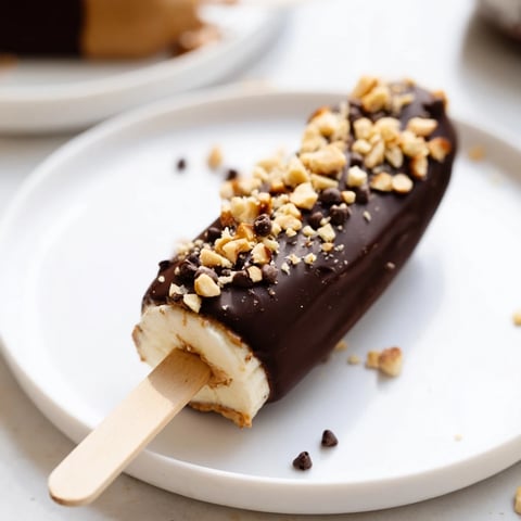 Frozen Banana Chocolate Pops on a tray, ready to enjoy as a refreshing and chocolatey dessert.
