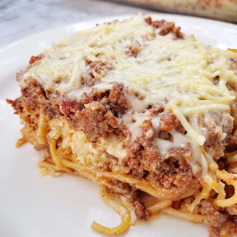 A bubbly, cheesy top of Million Dollar Spaghetti, showcasing layers of creamy, rich Italian-American comfort food.