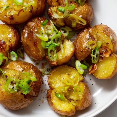 Golden, crispy Smashed Green Onion Potato Bombs, a vegetarian side boasting a delightful crunch and fresh green onion flavor.