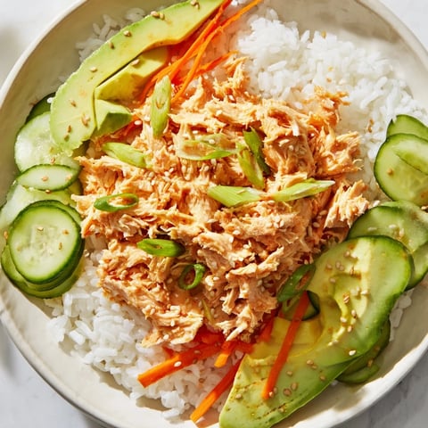 Steaming Spicy Canned Salmon Rice Bowl with colorful veggies, ready for a quick and flavorful dinner.