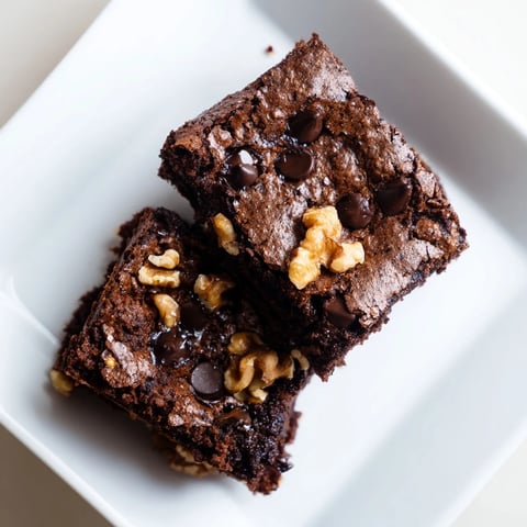 Fudgy Greek yogurt brownies, warm and chocolatey, ready to serve with a sprinkle of extra chips.