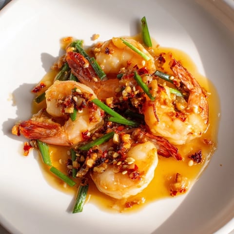 Golden, garlic butter shrimp sizzling in a pan, ready to be tossed with savory sauce.