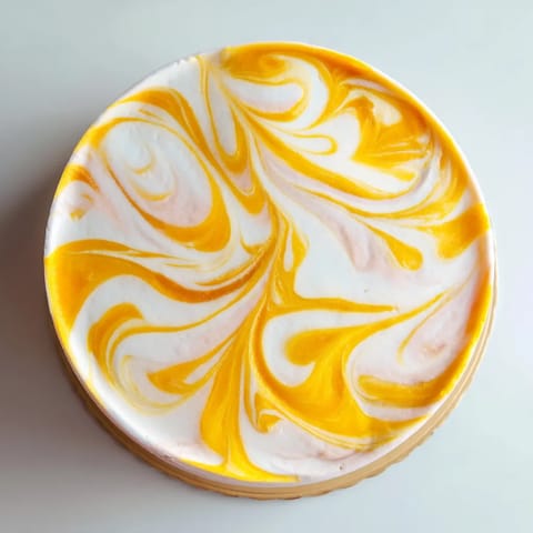 A yellow and white dessert on a white plate.