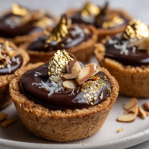 A plate of chocolate desserts with gold sprinkles.