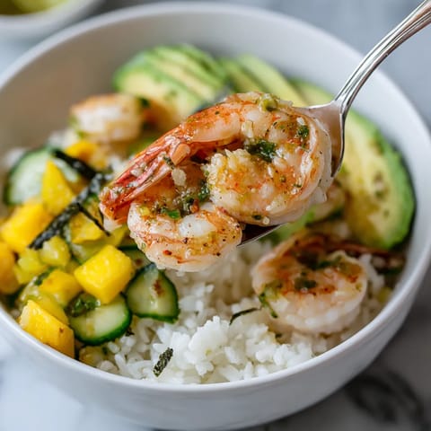 A bowl of food with shrimp and vegetables.