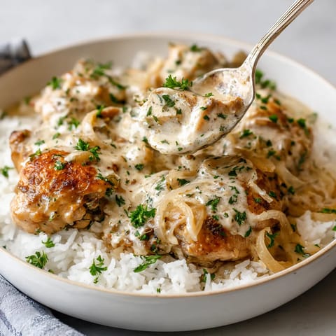 A bowl of food with a spoon in it.