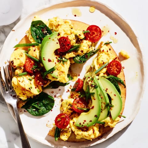 Creamy Avocado Scrambled Egg Breakfast Pizza, a satisfying morning meal baked until bubbly.