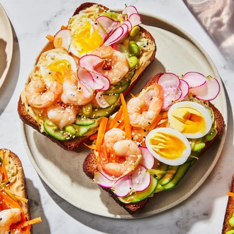 Close-up of Japanese Bento Open-Face Sandwiches; creamy avocado and sliced egg shine.