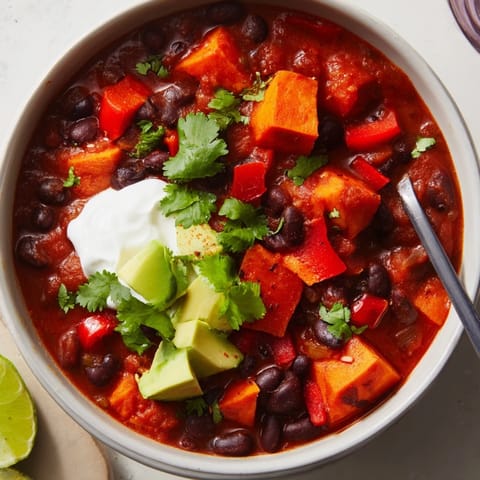 Vibrant bowl of Sweet Potatoes & Black Bean Chili, perfect for cozy nights.  