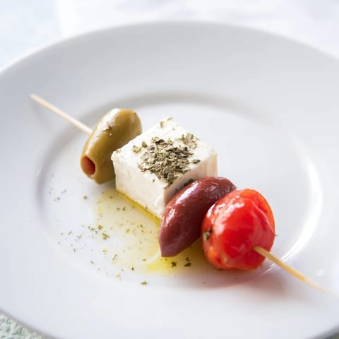 Mediterranean Holiday Cheers Olive and Feta Skewers drizzled with olive oil, ready for your celebration feast.