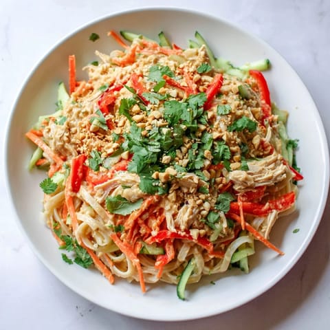 Enjoy a summery serving of Thai-Inspired Peanut Chicken Pasta, a flavorful no-cook pasta salad.
