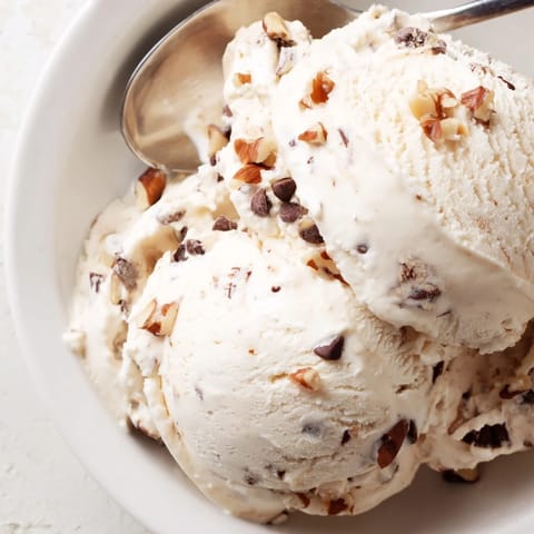 Cool, refreshing cottage cheese ice cream, swirled with fresh berries, looks delicious.