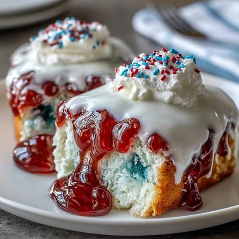 Festive Patriotic Poke Cake with creamy white chocolate ganache ready for celebration.