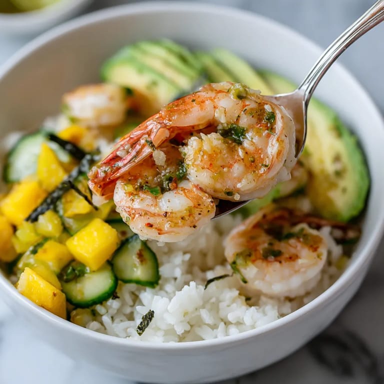 A bowl of food with shrimp and vegetables.