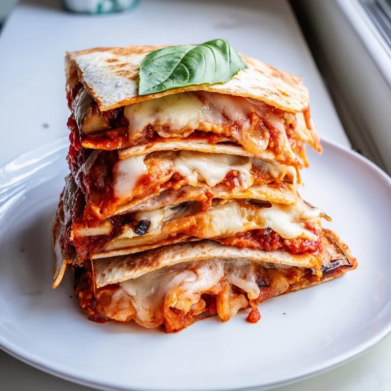 Crispy tortillas filled with Cheesy Eggplant Parmesan Quesadillas, bursting with melty cheese goodness.  