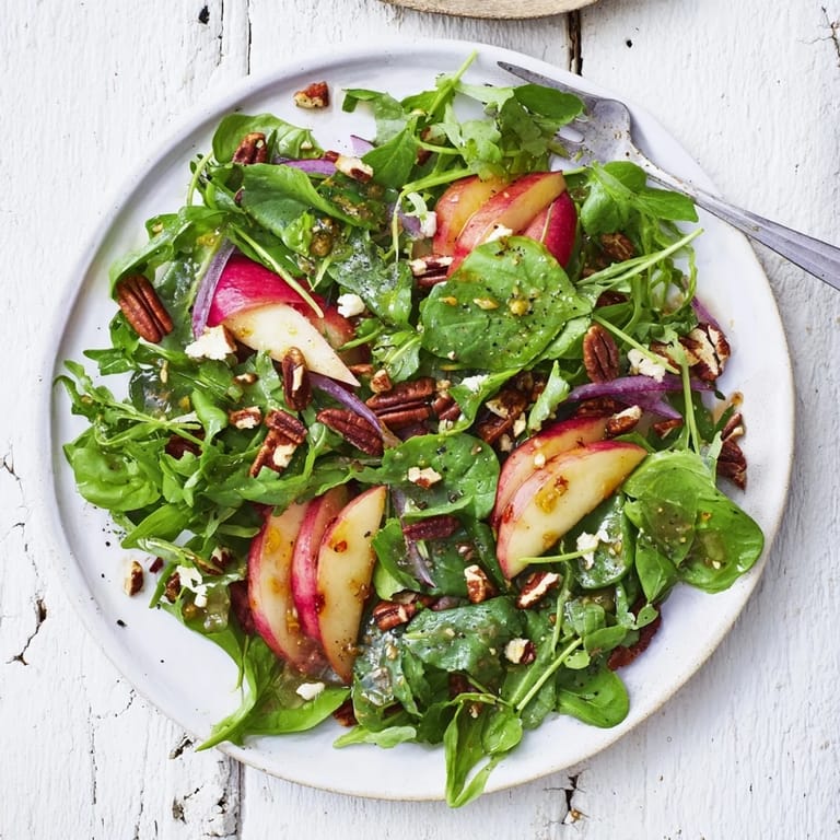 Refreshing Apple Cider Vinaigrette Salad topped with warm, fragrant roasted nuts.