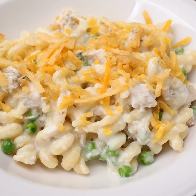 Creamy Homemade Tuna Noodle Casserole with a bubbling cheese layer and crunchy onion topping.