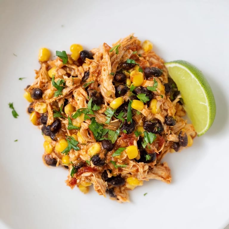 Shredded slow cooker salsa chicken with corn and beans, a flavorful main course for dinner tonight.
