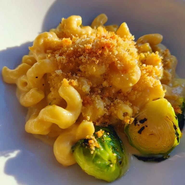 This sheet pan mac and cheese is a comforting blend of pasta, cheese, and roasted Brussels sprouts.