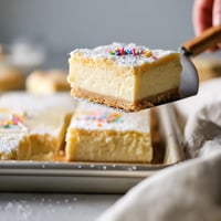 A person is cutting a piece of cake.