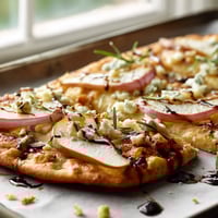 A pizza with blue cheese and onions.