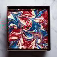 A slice of cake with blue and red swirls.