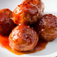 Slow Cooker Peach Glazed Meatballs simmer in a sweet and tangy sauce, served from the slow cooker for a party appetizer.