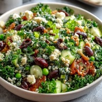 Bright lemon vinaigrette spring salad with radishes and peas, showcasing crisp greens, vibrant vegetables, and zesty citrus dressing.  