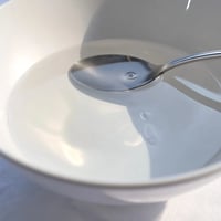 Refreshing glass of infused water with vibrant fruit slices and mint leaves.  