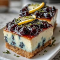 Creamy no-bake lemon blueberry cheesecake bars with vibrant fruit swirls.